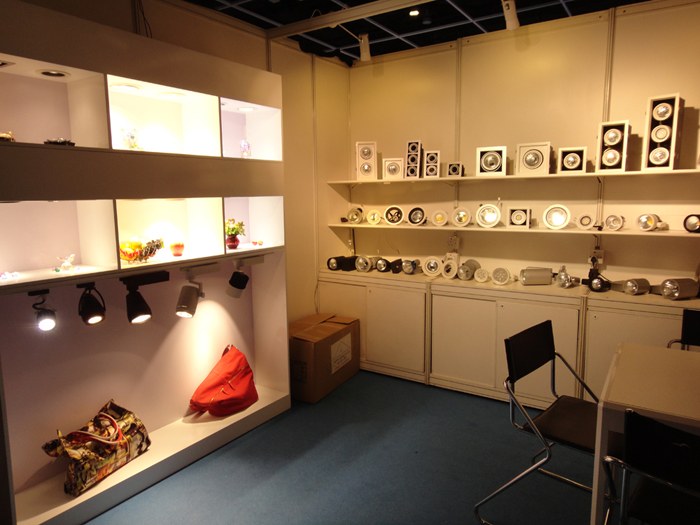 Lighting display shelves and a meeting table inside the KAIFON stand.