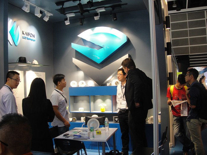 People gathered around a table inside the KAIFON stand.