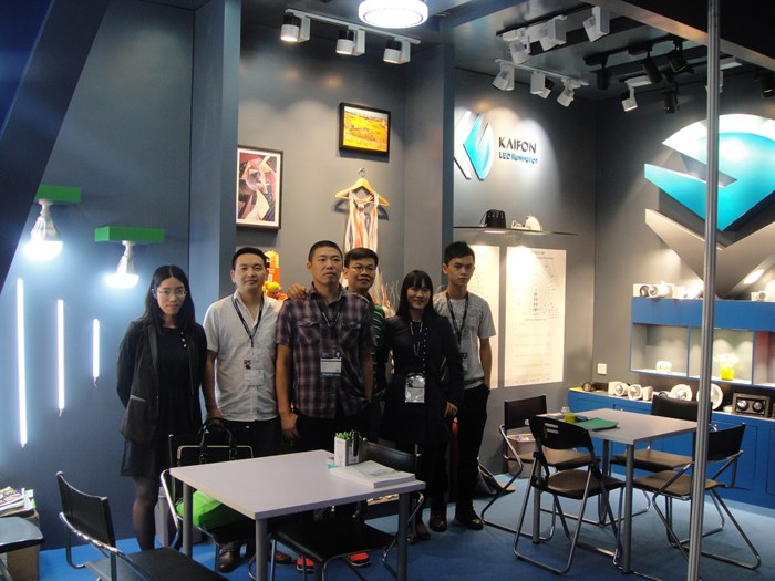A group standing beside the KAIFON exhibition display.