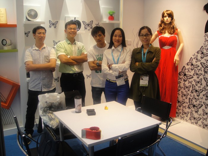 People standing near the exhibition meeting table.