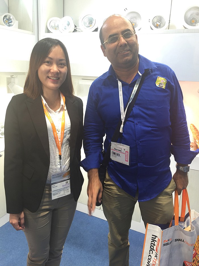 Two people standing beside the illuminated product display.