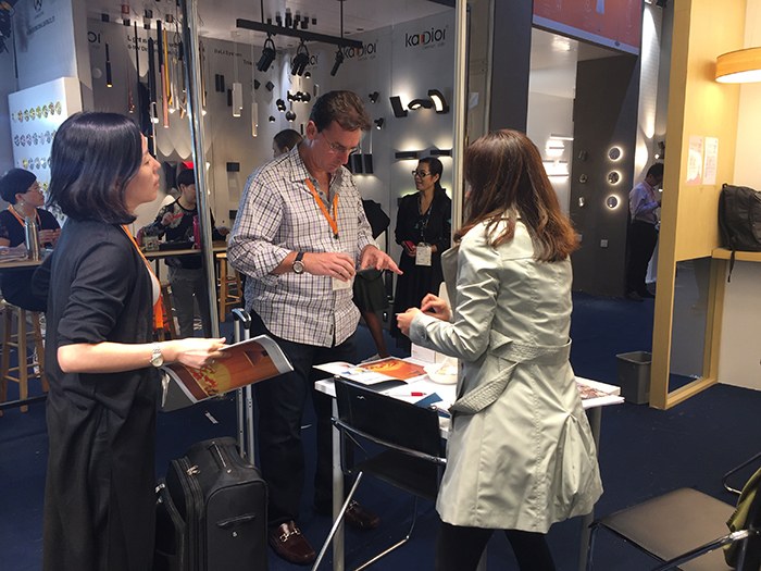 People reviewing documents beside the lighting display.