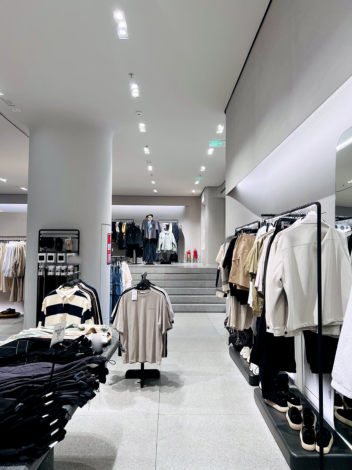 Three-head recessed grille lights along a retail aisle